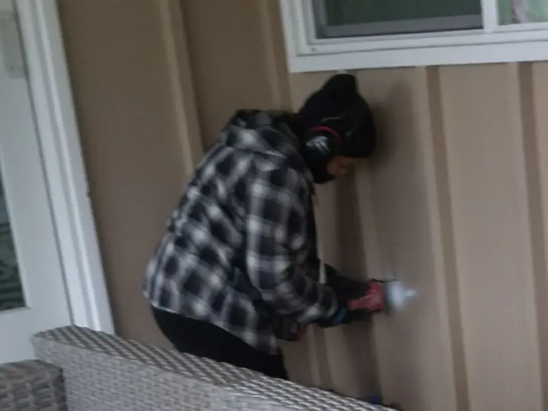 Professional electrician installing an exterior outlet in Stowe