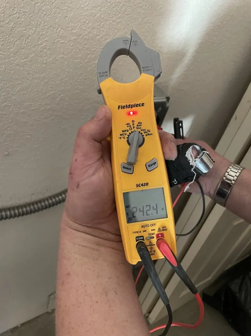 Voltage testing with clamp meter during Recessed Lighting Installation in Stowe